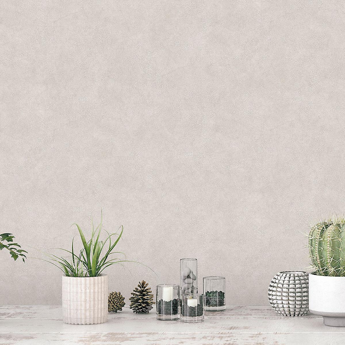 Textured wallpaper in a soft beige hue featuring a veining leaf pattern, complemented by decorative plants and glass vases on a rustic white table.