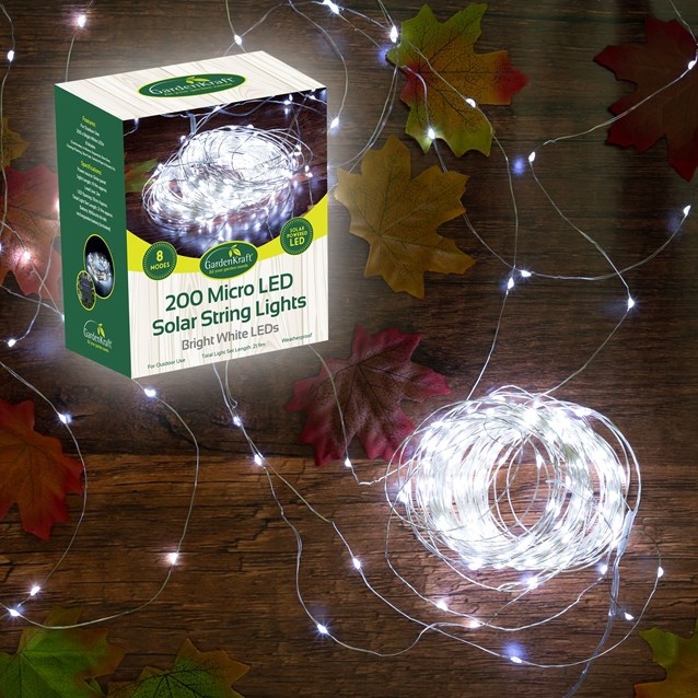 200 micro solar LED string lights by GardenKraft, featuring bright white LEDs on a thin, flexible wire, surrounded by autumn leaves and packaged in a green and white box.
