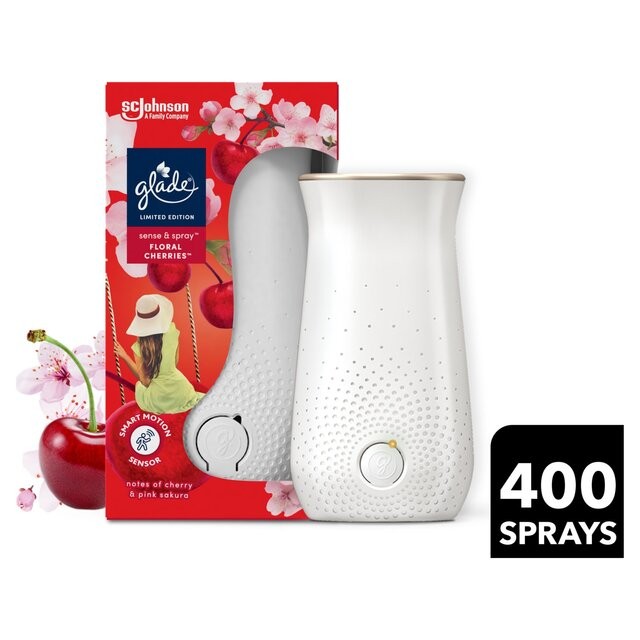 White Glade Sense & Spray holder with a gold top, featuring a floral cherries scent refill, packaged in a colorful box adorned with cherry blossoms and a woman wearing a hat.