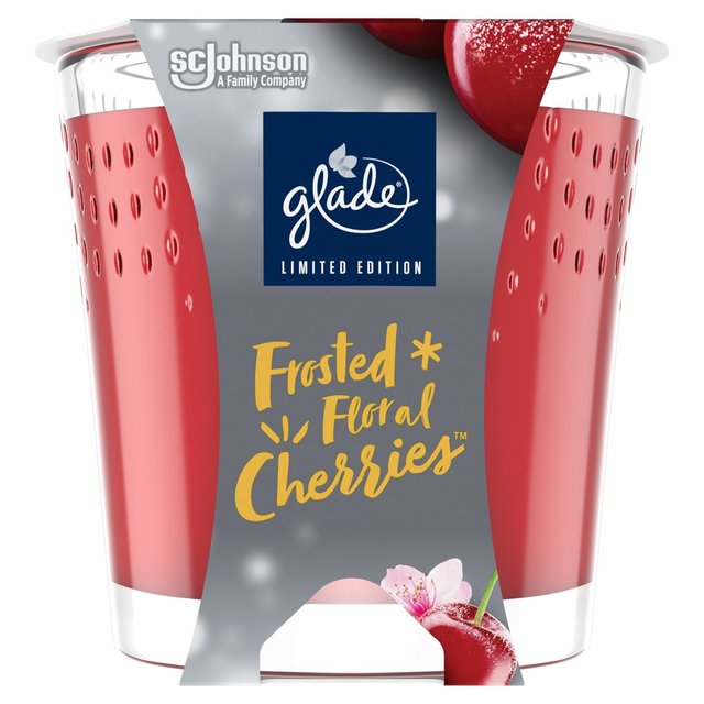 Red frosted candle container with a clear base, featuring a floral cherries design and gold text reading "Frosted Floral Cherries," labeled as a limited edition by Glade.