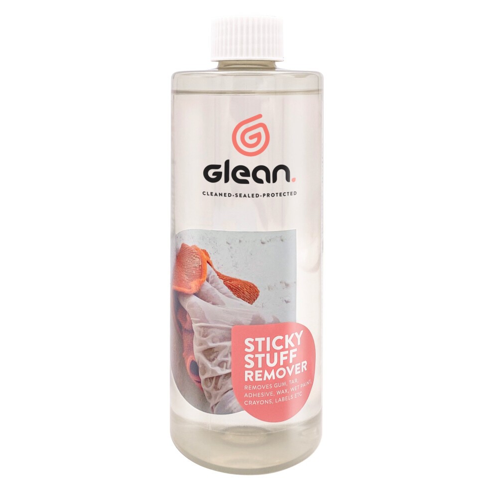 Clear plastic bottle containing 500ml of Glean Sticky Stuff Remover Liquid, featuring a red and white label with text and a logo, and a white screw-on cap.