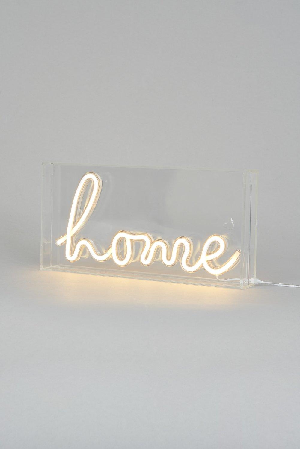 White acrylic light box featuring the word "home" in a glowing neon style, with a clear base and soft illumination.