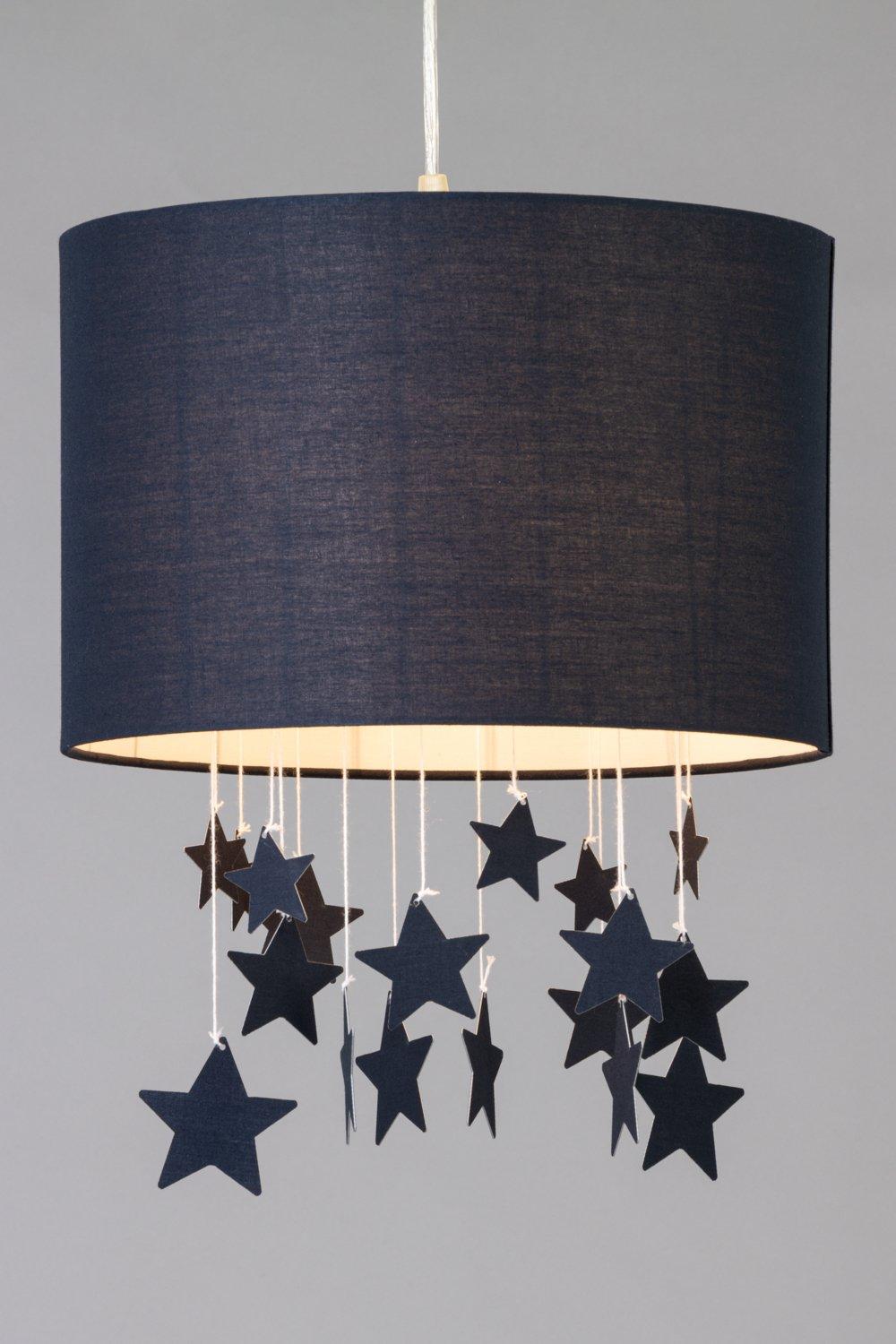 Navy fabric light shade with a cylindrical shape, featuring hanging star cutouts in varying shades of navy, creating a whimsical glow effect.