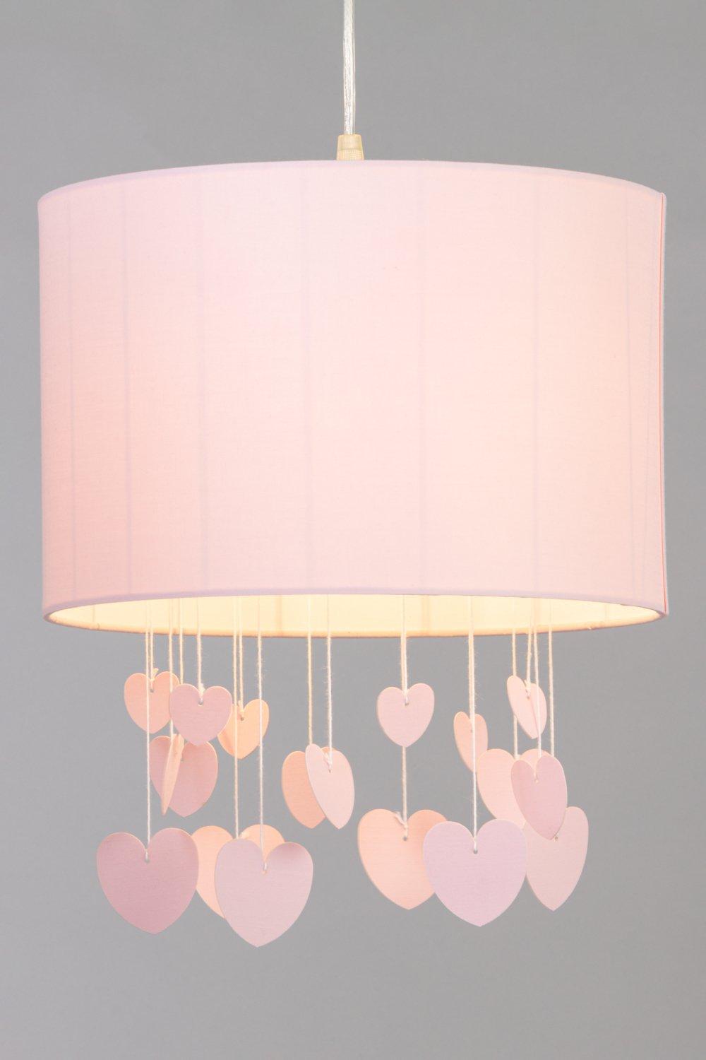 Pink cylindrical light shade with a textured fabric finish, featuring dangling pink hearts of various sizes, creating a whimsical and charming design.