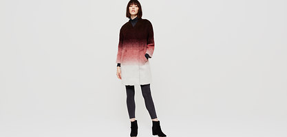 Ombre coat featuring a gradient from dark brown to soft pink, made of a cozy material, with a shawl collar and side pockets, paired with leggings and ankle boots.