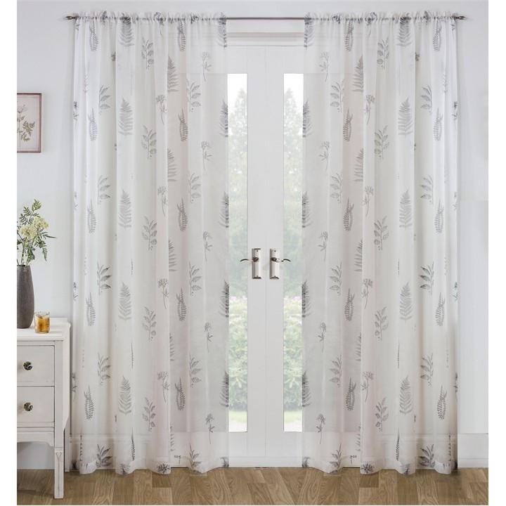 Sheer grey voile panel featuring an all-over leaf pattern, designed by Tyrone Textiles, with a delicate, airy texture, ideal for adding elegance to any room.
