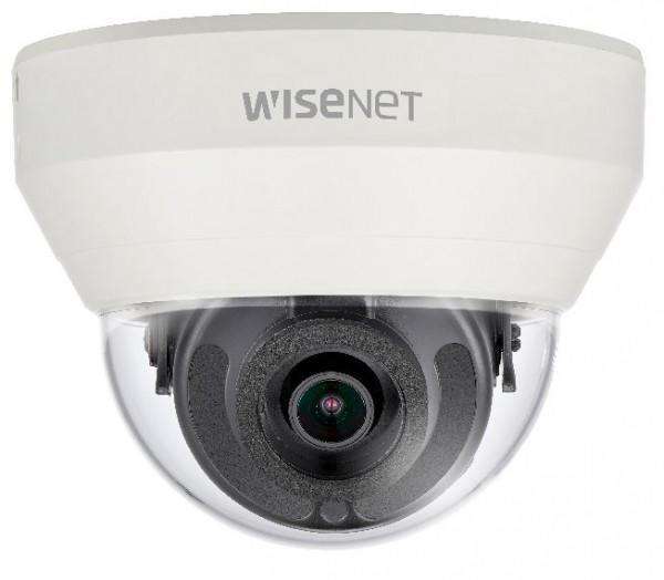 White dome-shaped security camera with a clear lens and black interior, featuring the "Wisenet" logo on top, designed for indoor surveillance.