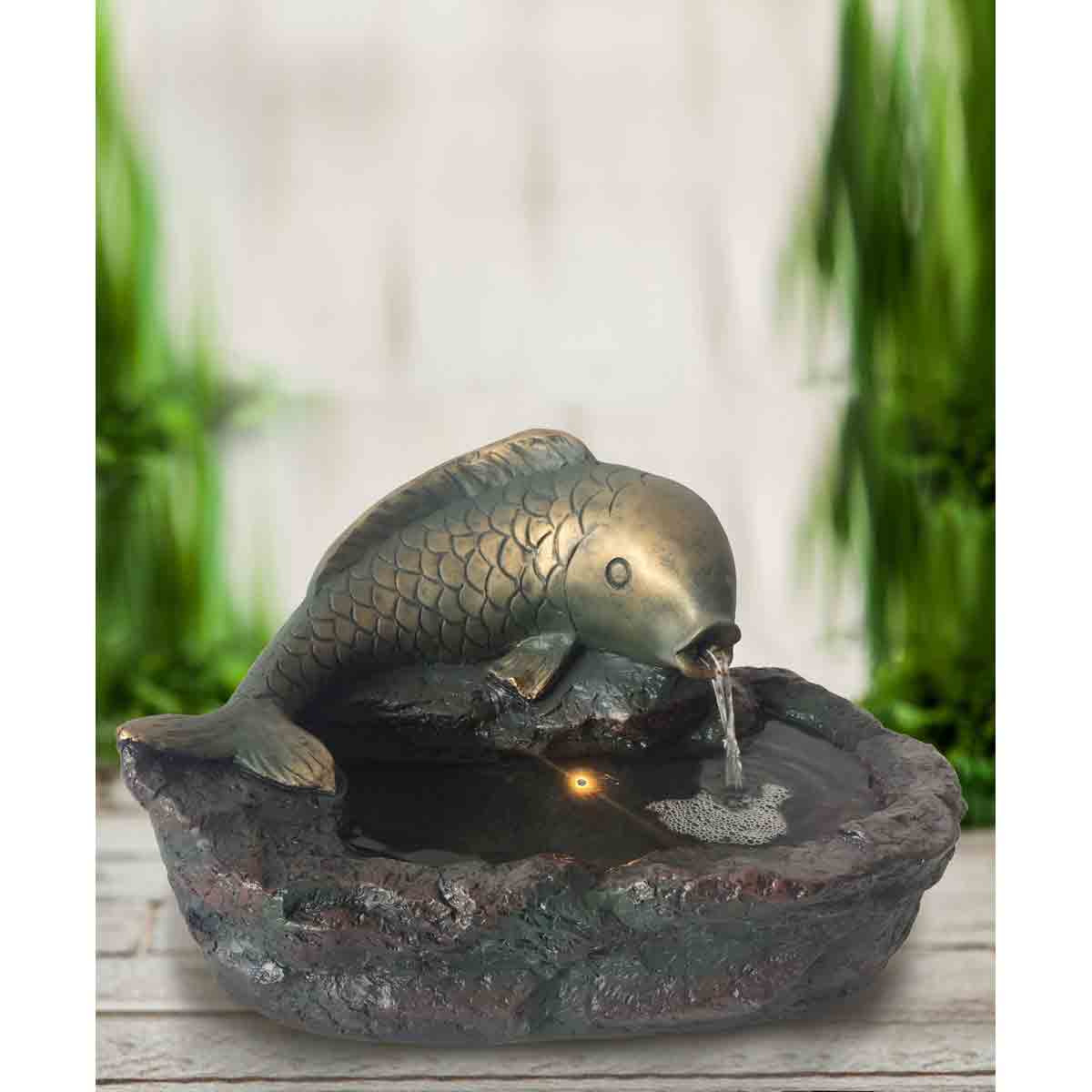 Grey Heissner fish water feature with a textured, rocky base and a detailed fish spouting water into a small pond-like basin.