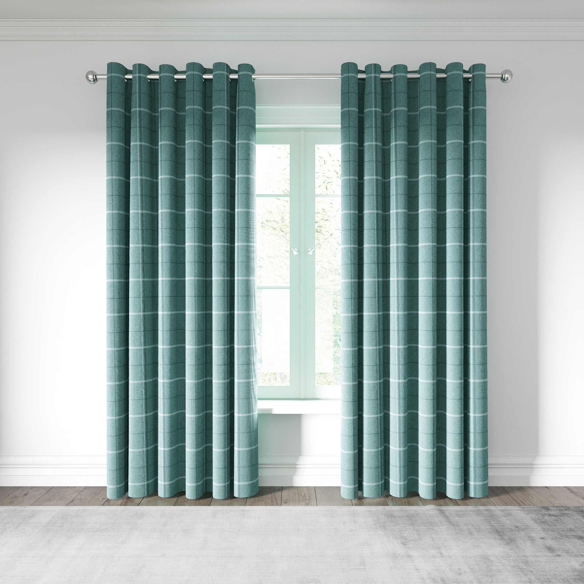 Woven lined curtains in a soft teal color with a subtle striped pattern, featuring eyelet rings, hanging elegantly by a window with natural light.