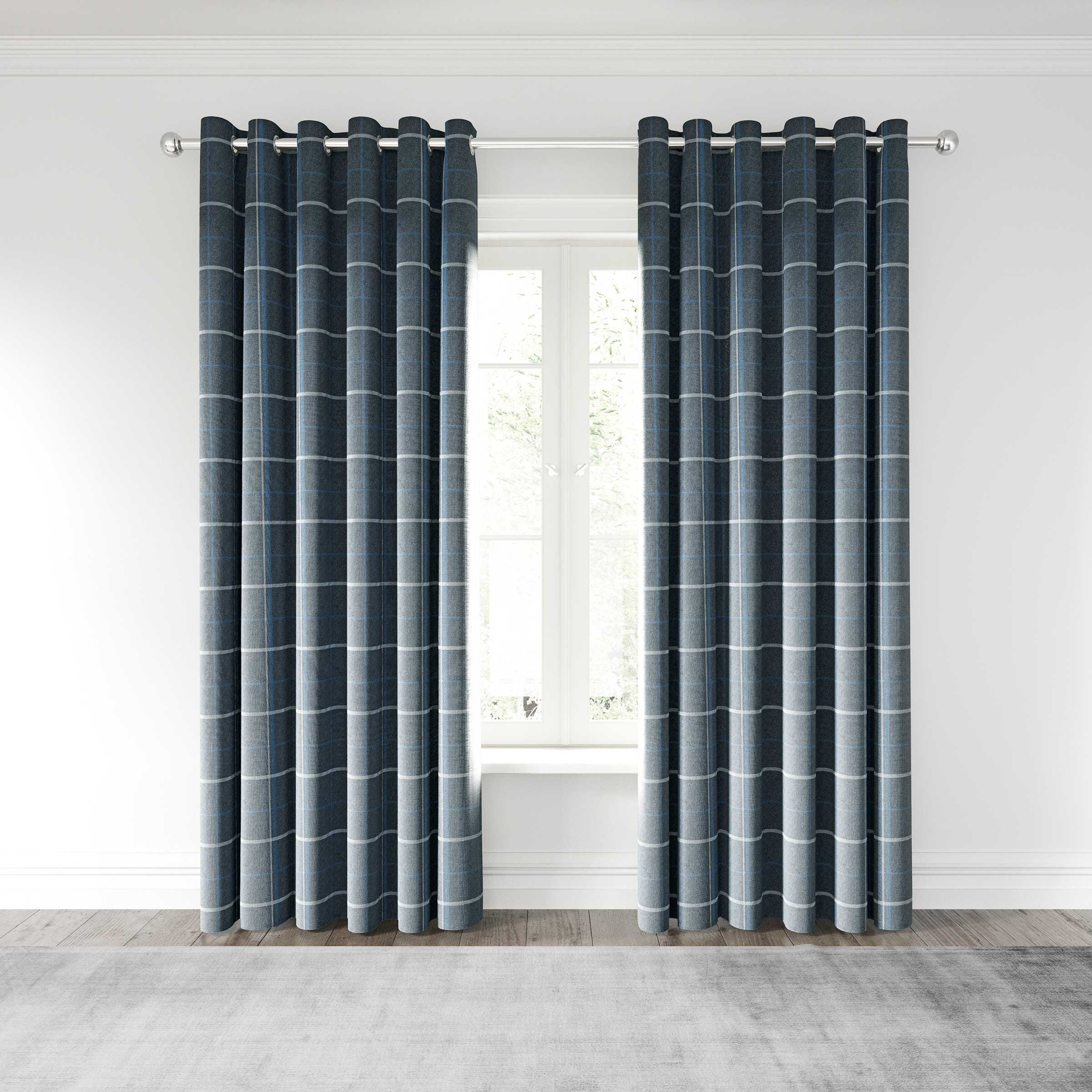 Woven lined curtains in a dark blue and grey grid pattern, featuring a modern design with grommet top for easy hanging, complementing a bright, airy window setting.