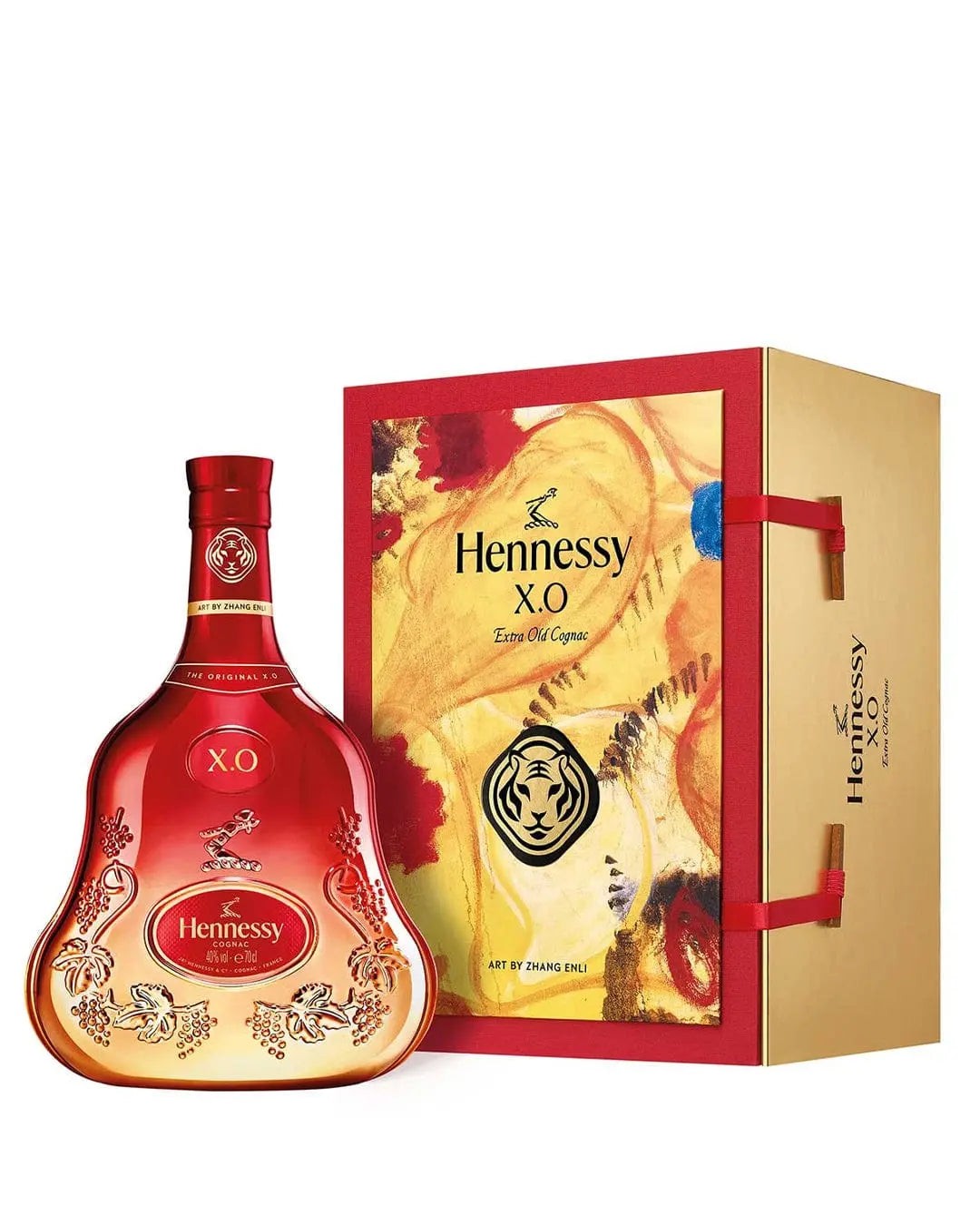 Elegant Hennessy X.O bottle in a curvy shape, featuring a rich amber hue, accompanied by a vibrant red and gold box decorated with a tiger design for Chinese New Year.