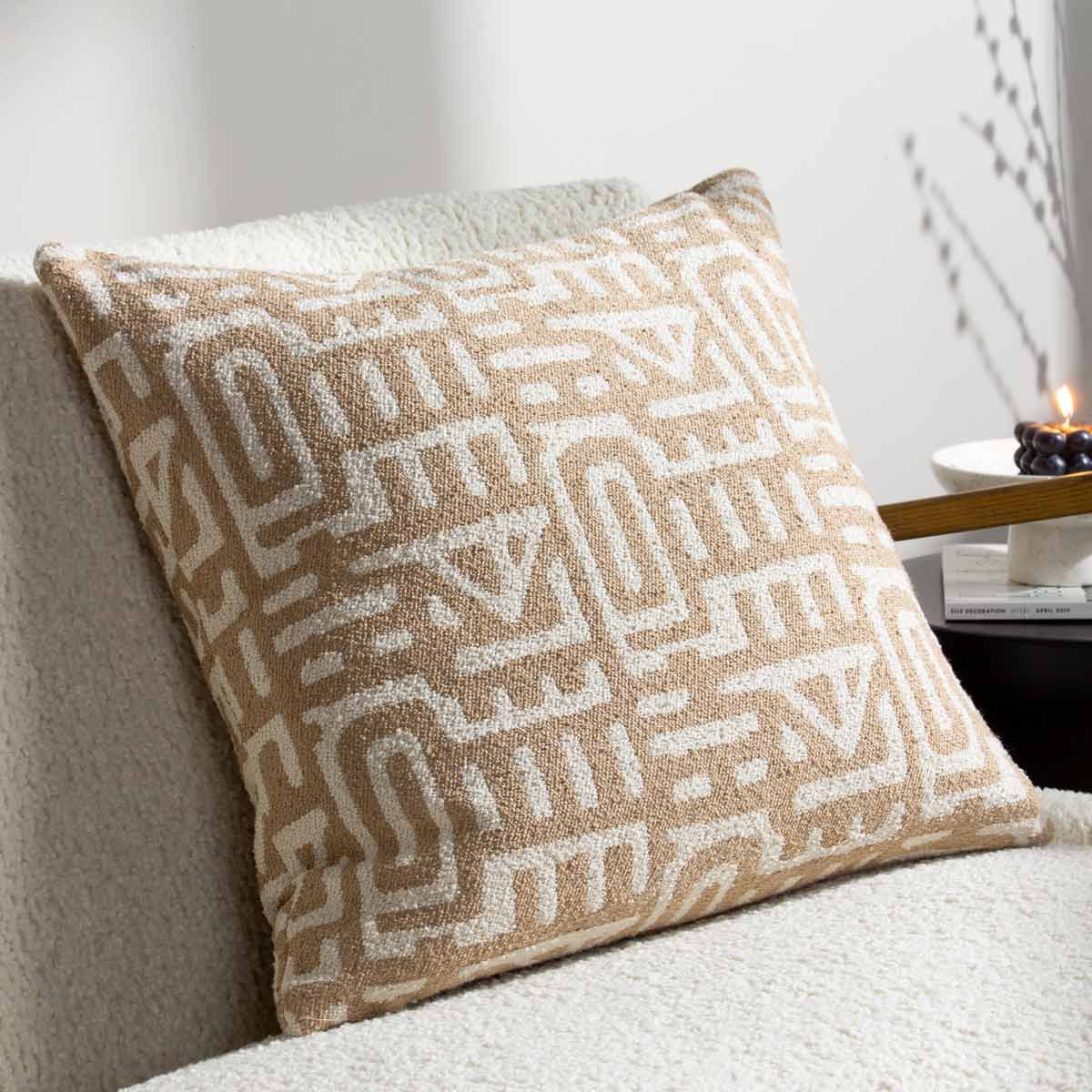 Brown woven jacquard cushion featuring a geometric pattern in cream, with a soft texture, designed to add a cozy touch to any space.