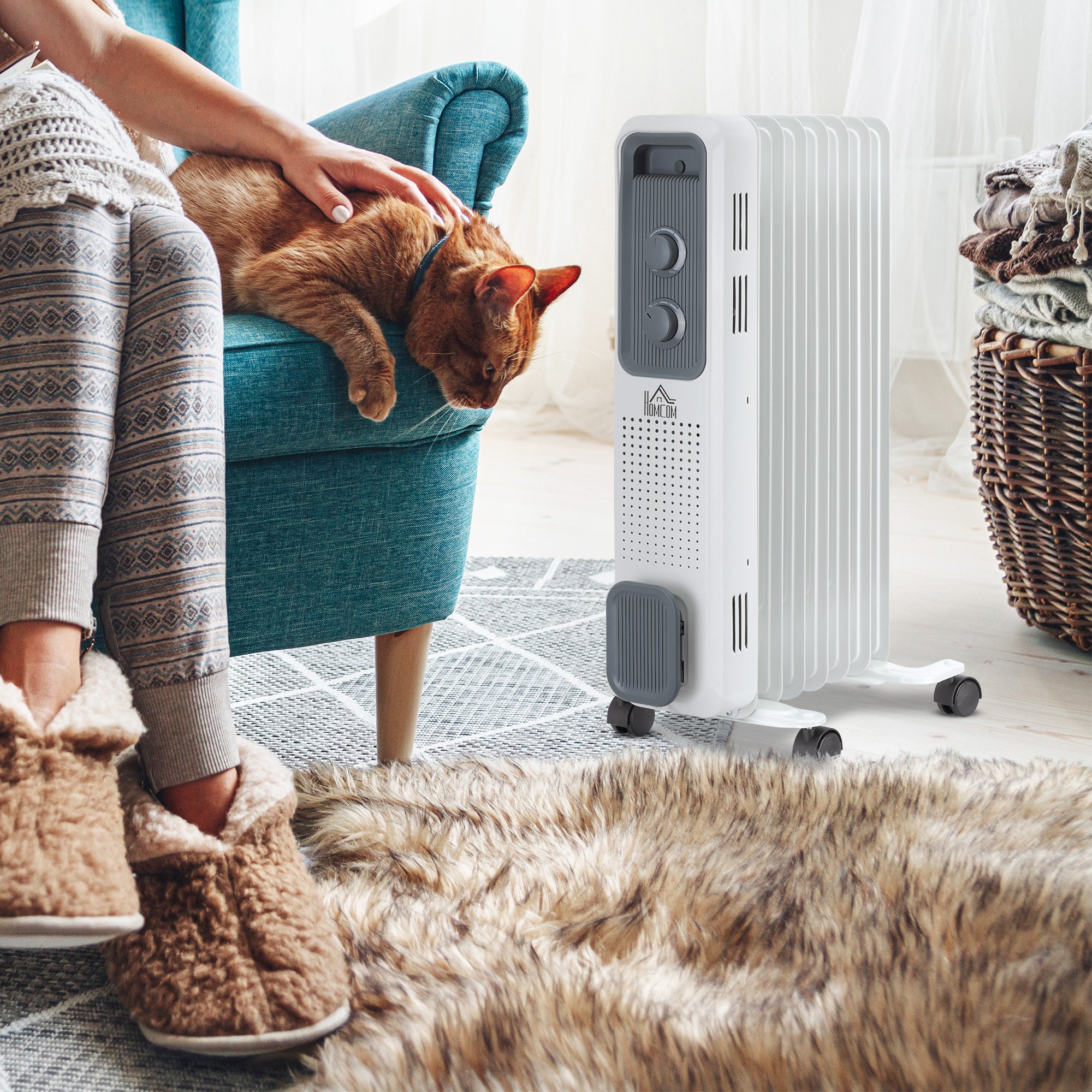 White HomCom Radiator Heater with adjustable temperature settings, featuring a sleek design, standing beside a cozy chair, with a person in slippers and a cat nearby.