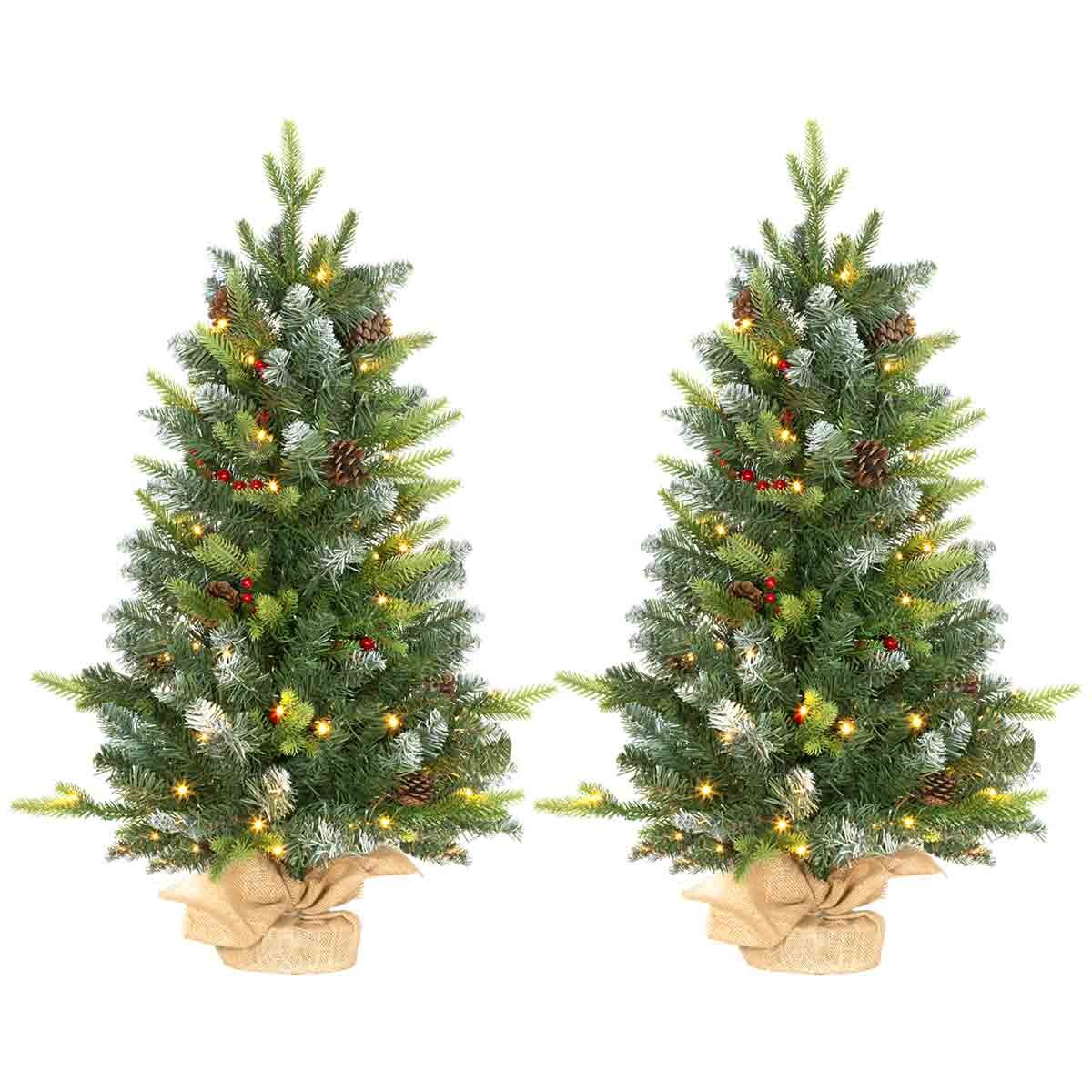 Two 3ft green tabletop Christmas trees with LED lights, decorated with pinecones and red berries, featuring a burlap-wrapped concrete base.