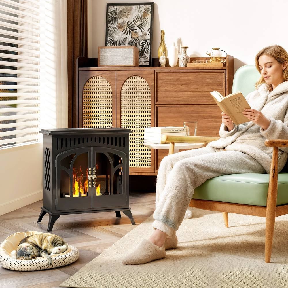 Black HOMCOM 22" bio ethanol fireplace stove with a glass door, featuring a sleek design, set in a cozy living room with a woman reading and a cat resting nearby.