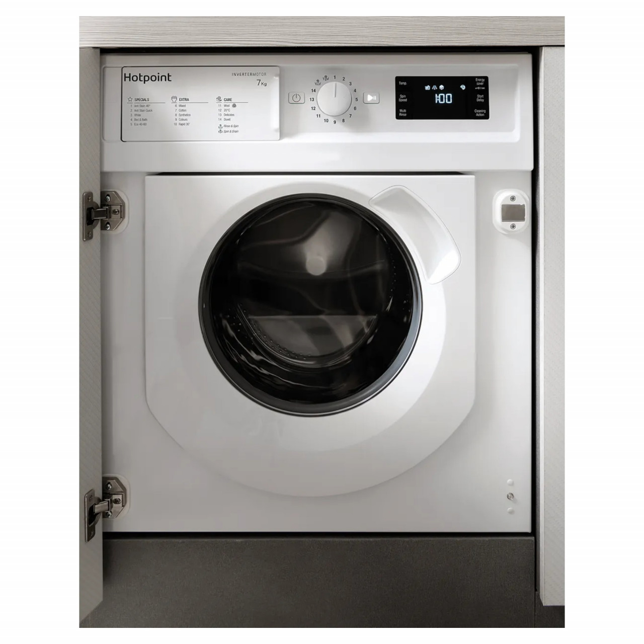 Built-in Hotpoint washing machine in white with a large circular door, digital display, control dial, and integrated design, fitting seamlessly into cabinetry.