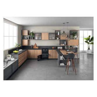 Black Hotpoint HDT67I9HM2C/UK 60cm electric double cooker with induction hob, featuring a sleek design, integrated oven, and modern kitchen setting with wooden cabinets and grey tiles.