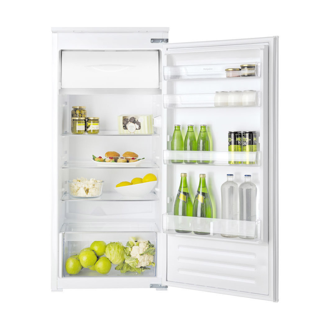 White Hotpoint refrigerator with a top freezer, featuring clear shelves filled with drinks, fruits, and vegetables, and a spacious design for organized storage.