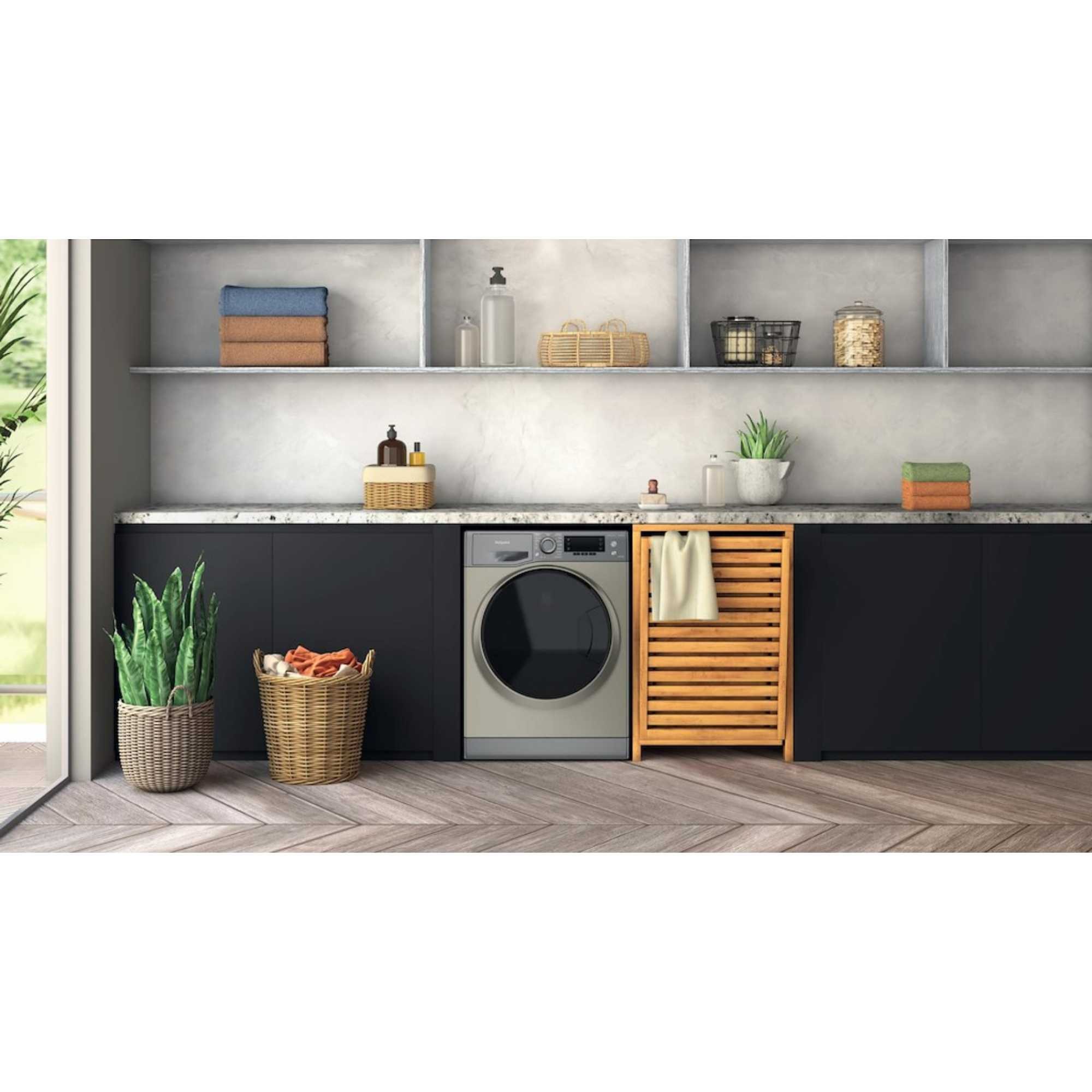 Hotpoint ActiveCare washer dryer in graphite, featuring an 8kg wash and 6kg dry capacity, 1400rpm spin, energy-saving steam function, set in a modern kitchen environment.