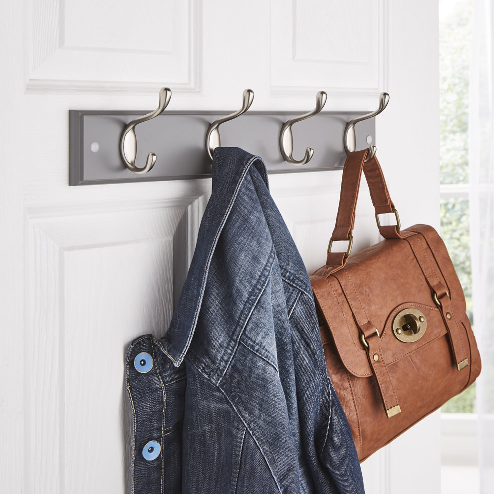 Wall mountable grey coat hook set featuring four double hooks with a sleek metallic finish, holding a denim jacket and a brown leather handbag.