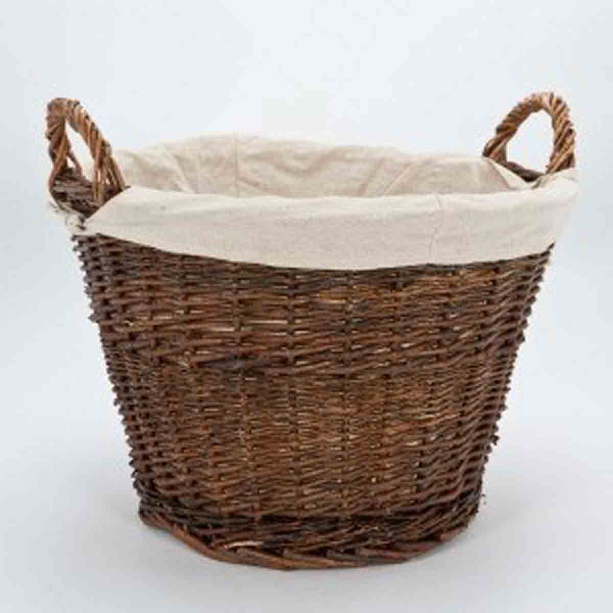 Brown wicker basket with a removable linen liner, featuring sturdy handles and a round shape, ideal for storing logs or other items.