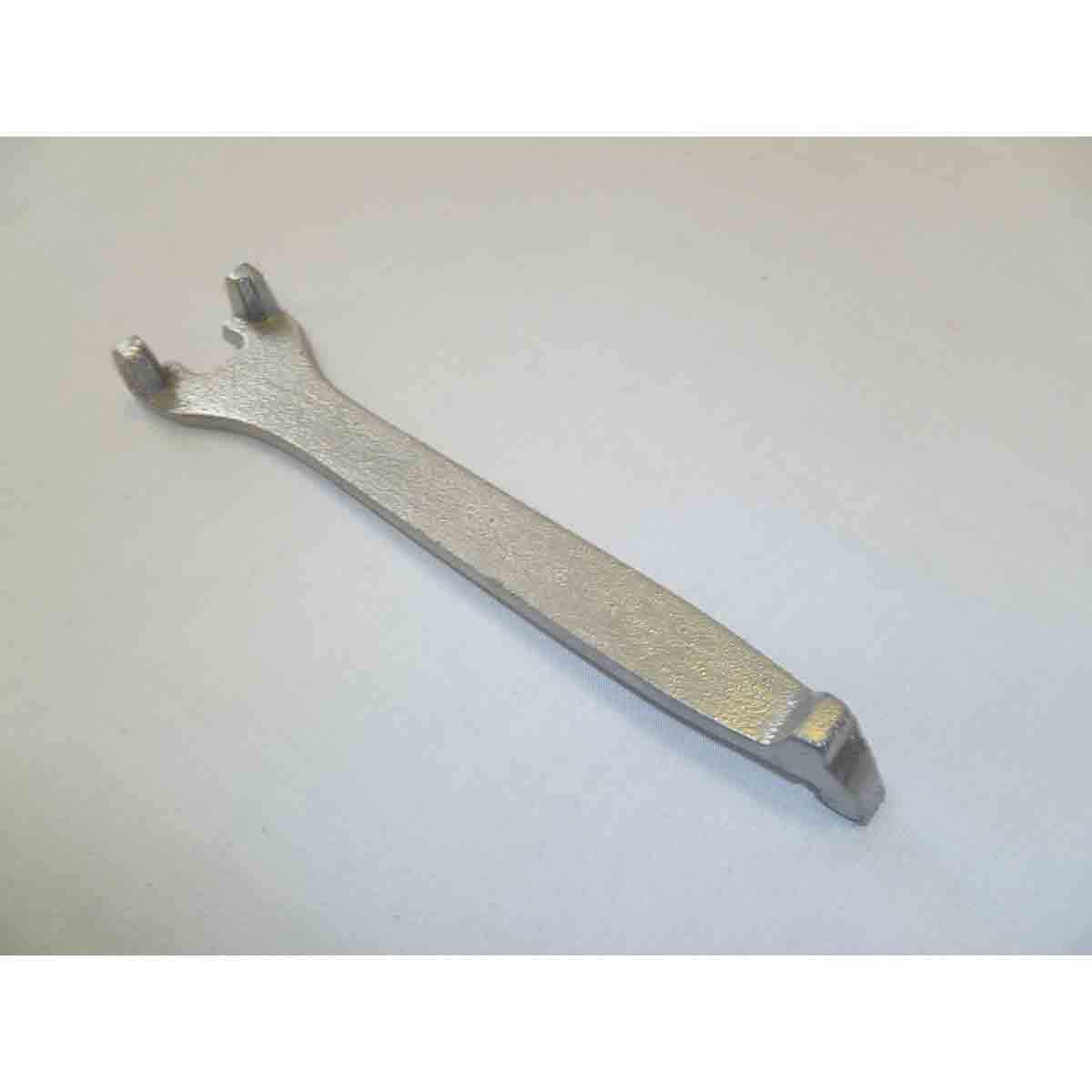 Silver metal ash pan handle with a textured surface, featuring two prongs at one end and a flat, elongated body for easy gripping and maneuvering.