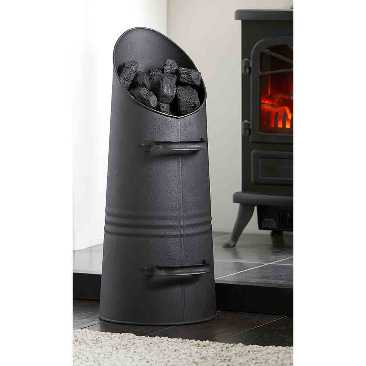 Black tapered coal skuttle hod with two handles, filled with black coal, designed for fireside use, featuring a smooth metal finish and a wide opening for easy access.