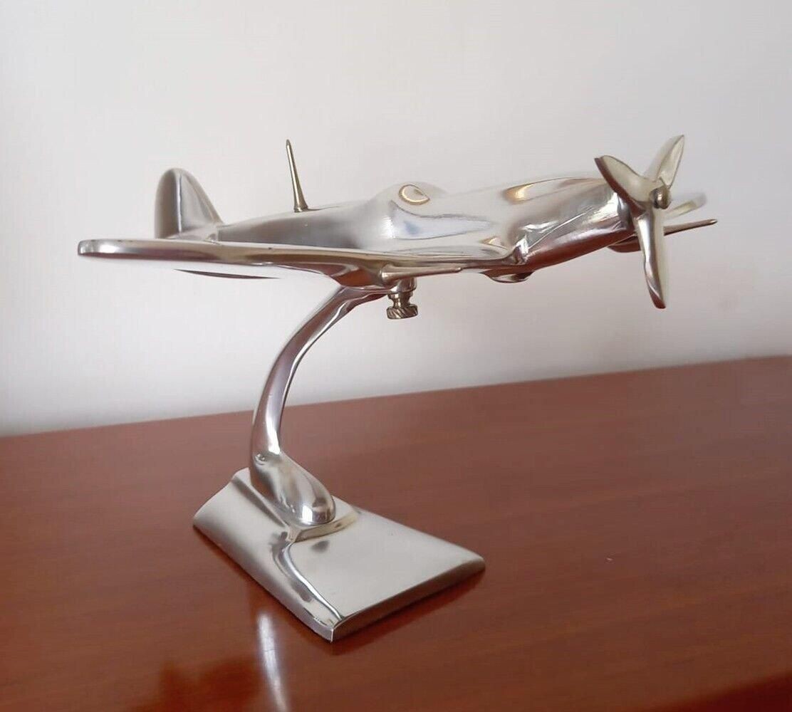 Aluminium Spitfire aeroplane ornament with a polished silver finish, featuring intricate details and a sleek design, mounted on a sturdy base.