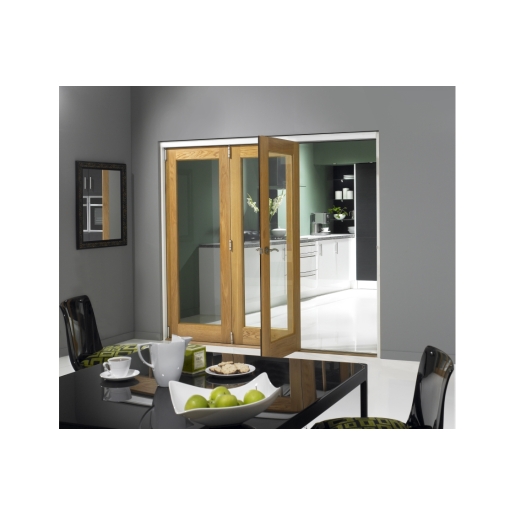 Oak veneer folding door with a light finish, featuring clear glass panels, set in a modern kitchen space with a black dining table and green accents.
