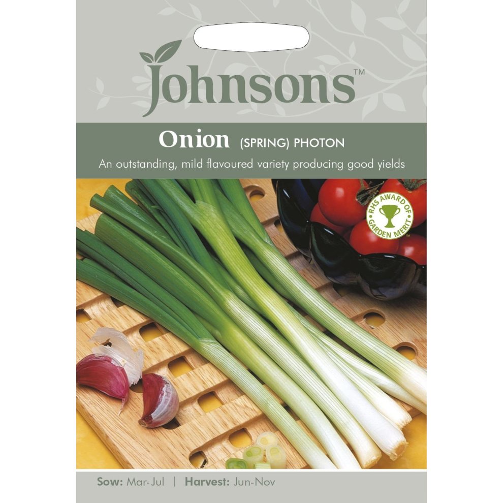 Johnson's Spring Onion Seeds - Photon packet featuring green spring onions on a wooden surface, with garlic cloves and tomatoes in the background, highlighting sowing and harvesting details.