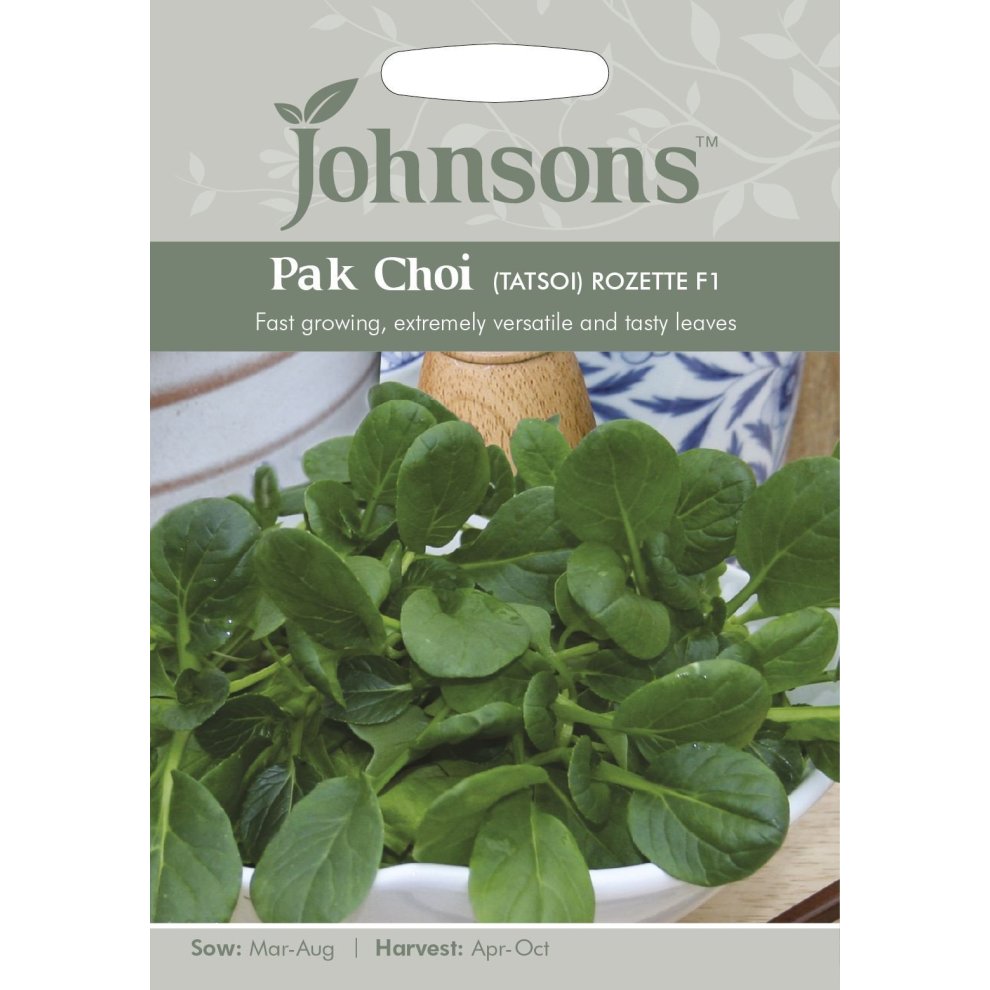 Green leafy vegetables in a white bowl, with a wooden pestle and mortar in the background; the pack features a light green label with "Johnsons" and product details.