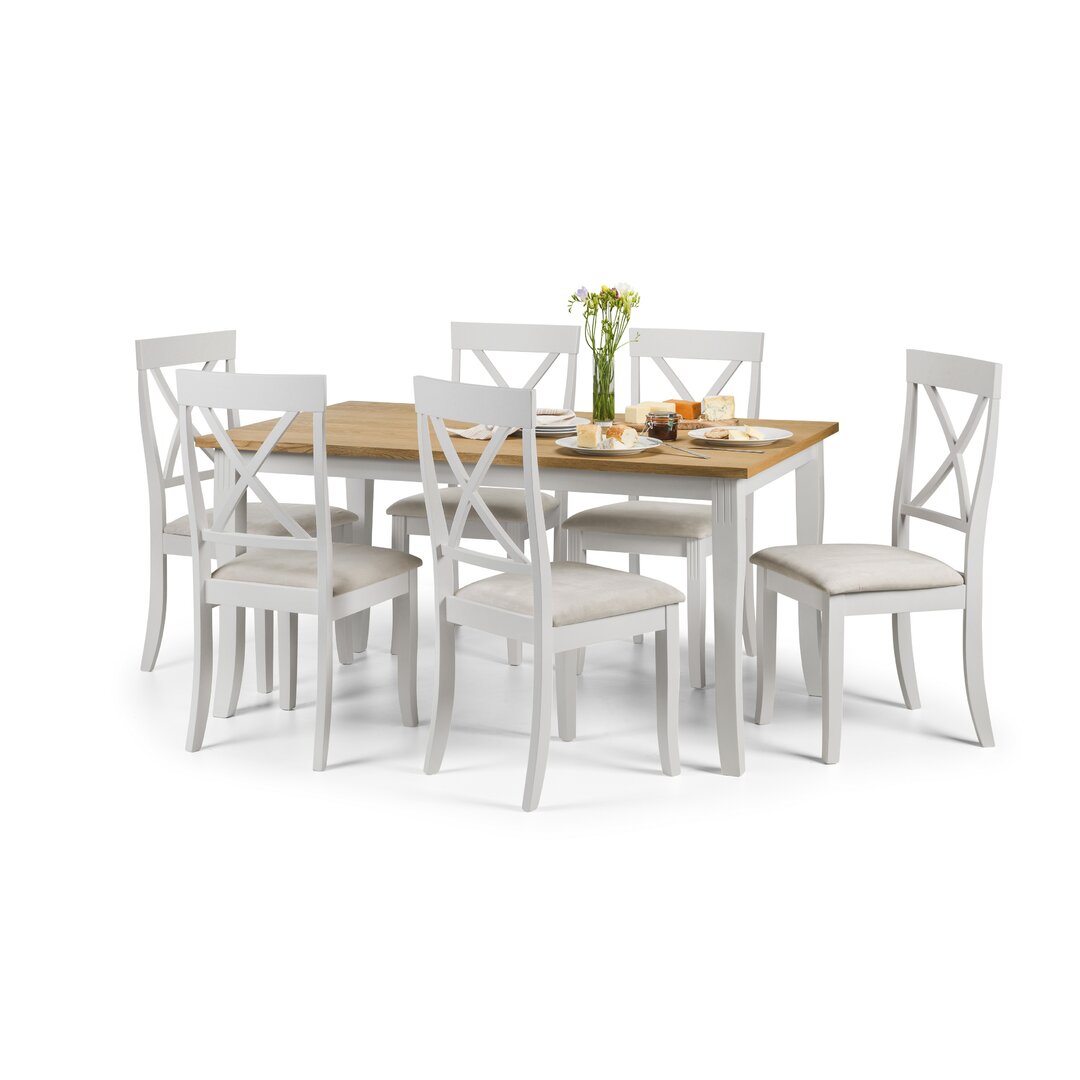 White dining set with six upholstered chairs and a rectangular wooden table featuring a natural wood finish, showcasing a modern farmhouse style.