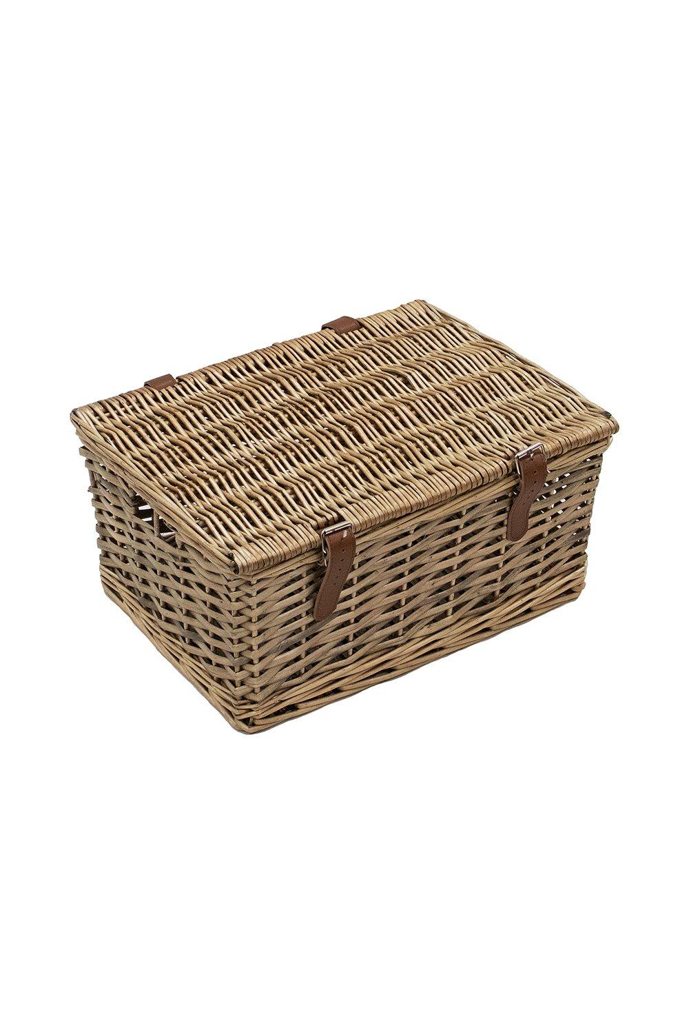 Handmade small buff wicker hamper featuring a textured woven design and faux leather straps for secure closure.