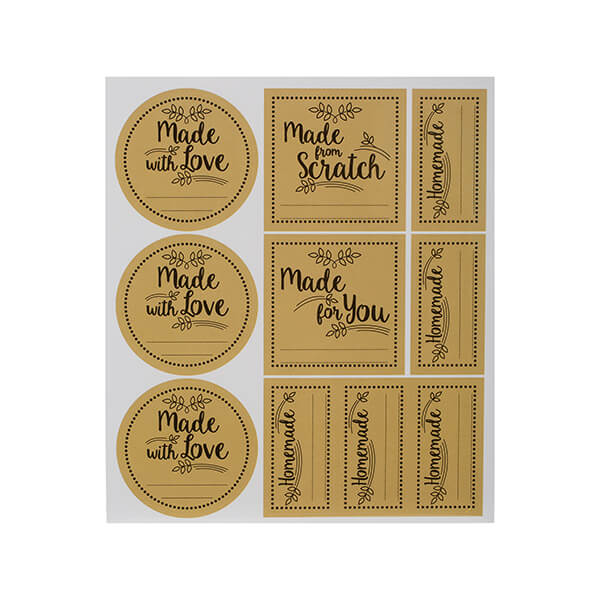 A set of gold-colored gifting labels featuring decorative black text, including phrases like "Made with Love" and "Homemade," arranged on a white backing sheet.