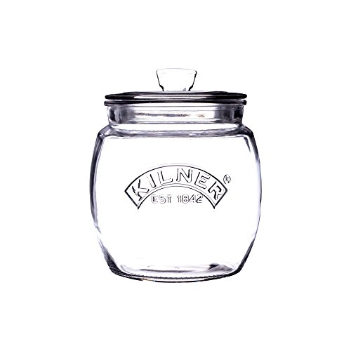 Clear glass storage jar with a rounded shape, featuring a black rubber seal and a glass push-top lid, embossed with "Kilner EST 1842," holding 850ml capacity.