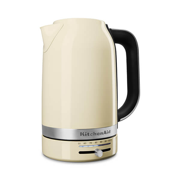 Almond cream-colored KitchenAid 1.7L kettle with a black handle, stainless steel base, and a temperature control dial on the front.