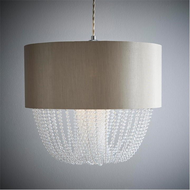 Grey fabric drum light shade featuring cascading beaded droplets, designed as a non-electric pendant to modernize home decor.