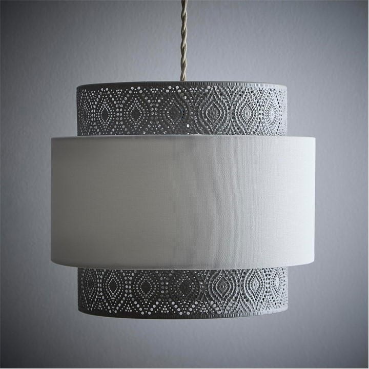 A stylish pendant light featuring a satin nickel finish with intricate cut-out patterns and a white linen shade, creating a modern and elegant look.