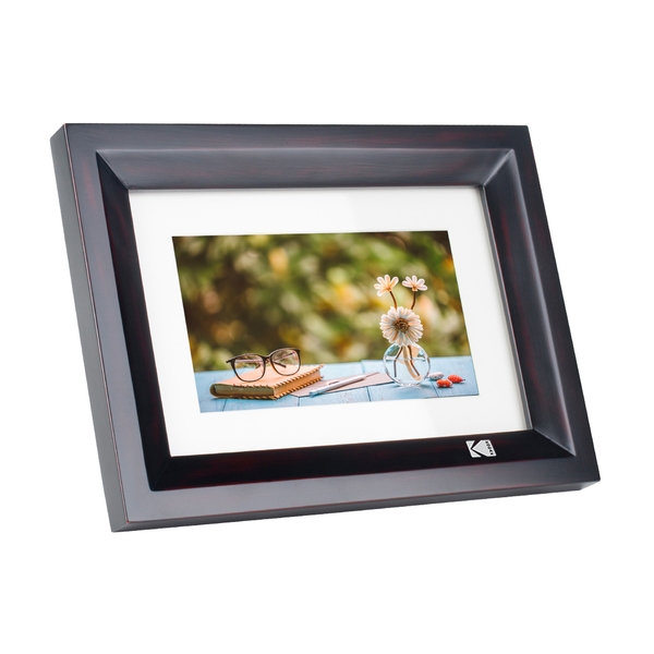 Black wooden digital photo frame with a sleek design, displaying a vibrant photo of flowers and glasses, featuring a 7-inch screen and Kodak branding in the corner.