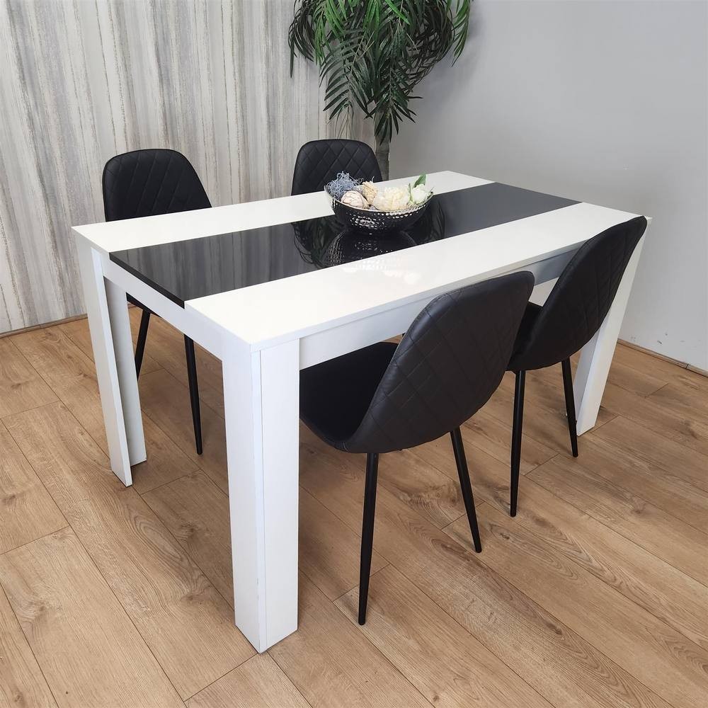 KOSY KOALA dining table features a white and black wood design with a glossy top, accompanied by four black leather chairs with quilted detailing.