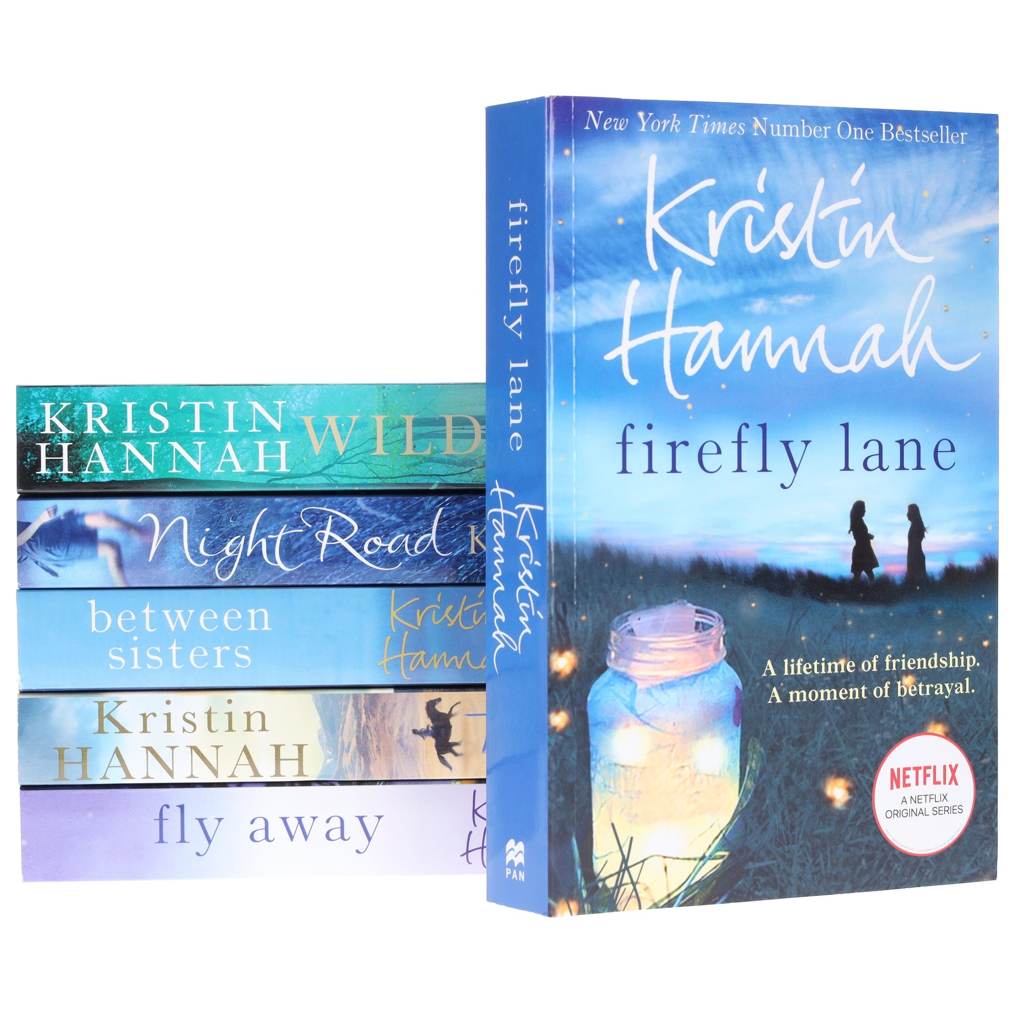 A collection of six Kristin Hannah books featuring colorful covers, including "Firefly Lane" with a blue background and a lantern, and titles like "Wild" and "Night Road" in varying shades.