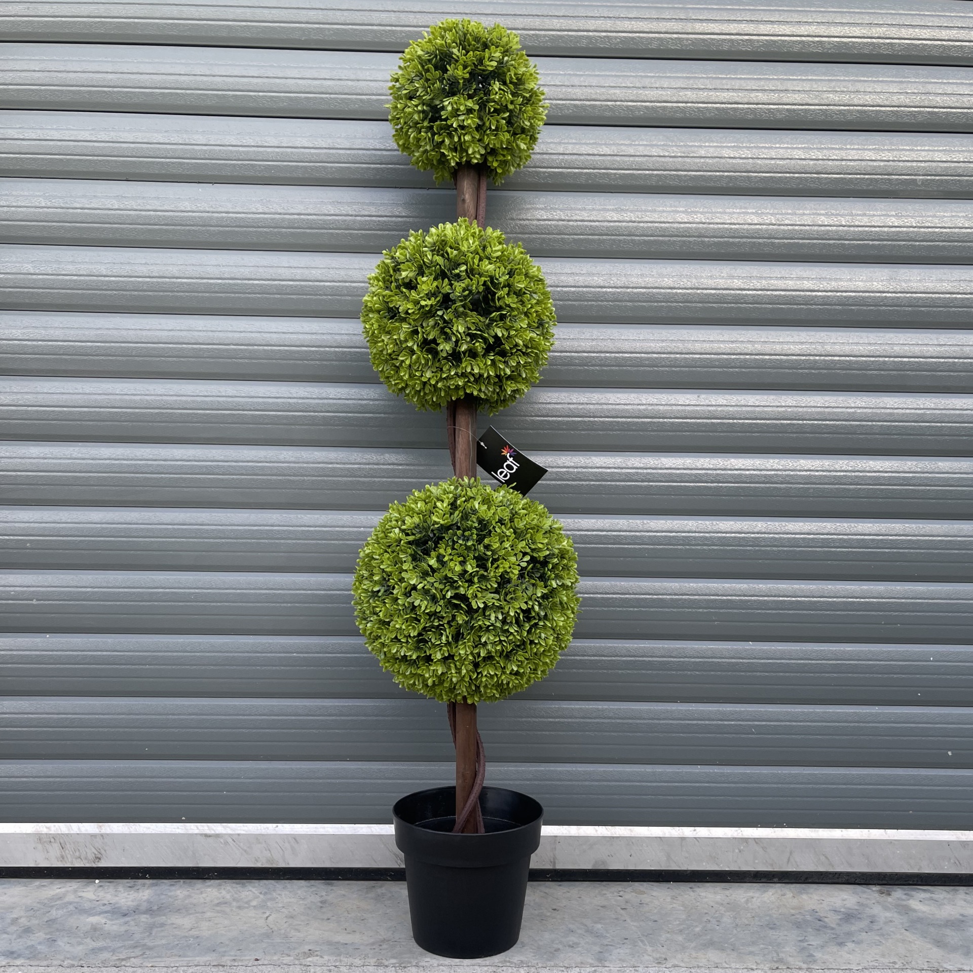 120 cm tall artificial topiary tree with three green spherical foliage balls, set on a twisted brown trunk in a black pot, against a gray background.