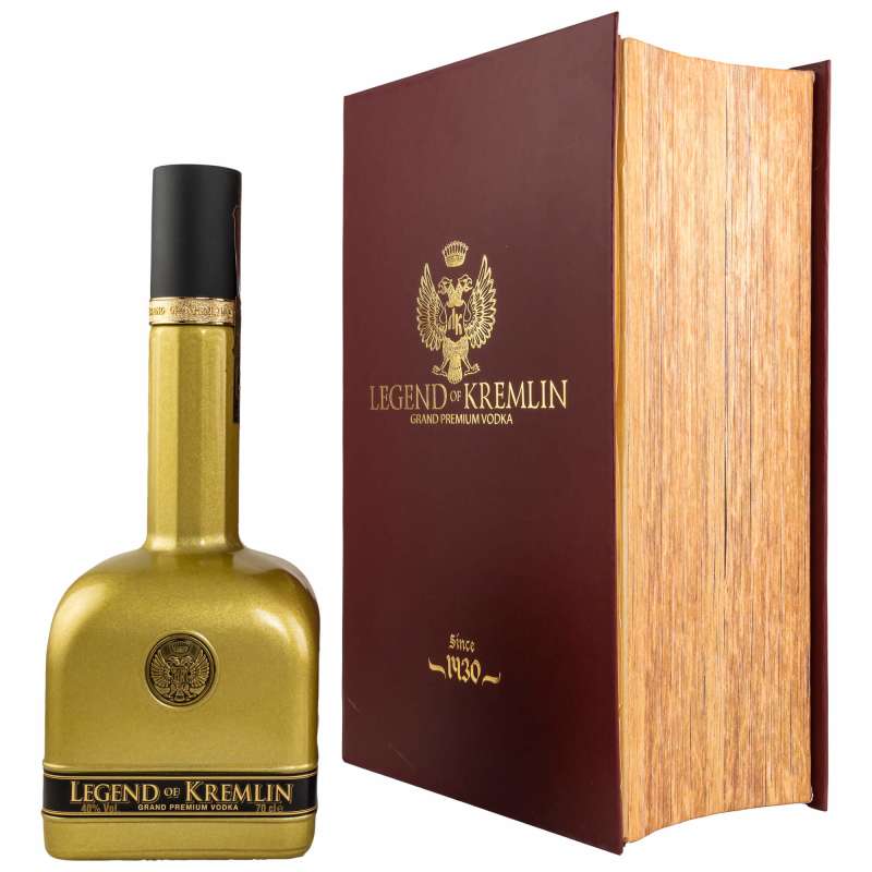 Gold bottle of Legend of Kremlin Vodka beside a large, red hardcover book with gold detailing, featuring the brand name and a crest, highlighting its premium quality.
