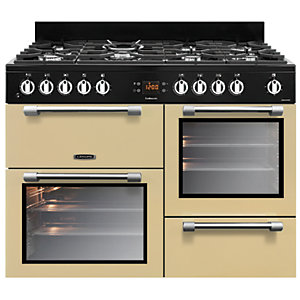 Cream-colored dual fuel range cooker with a 110cm width, featuring a black control panel, six gas burners, and two glass-fronted ovens with stainless steel handles.