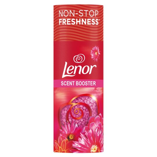 Bright pink cylindrical container with floral designs, featuring the Lenor logo and "Scent Booster" text, promoting the Desert Rose fragrance for laundry freshness.