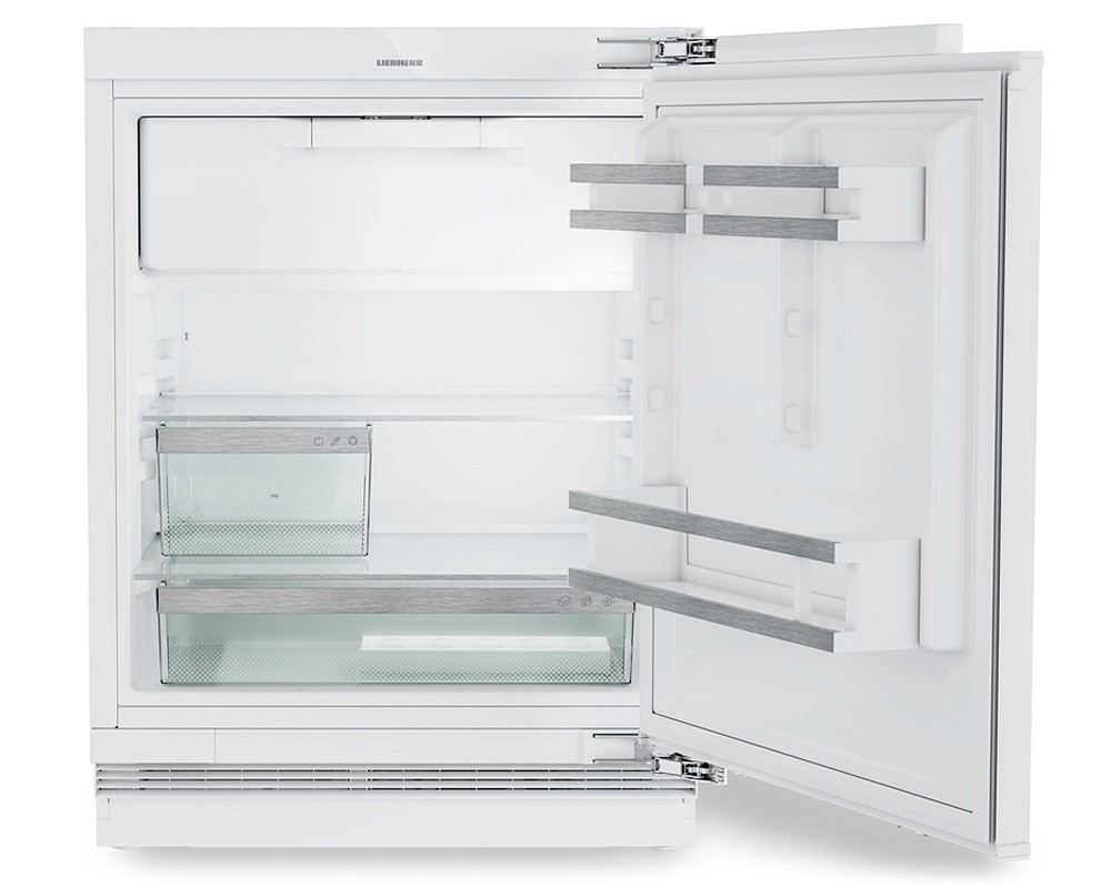 Fully integrated Liebherr Pure URD3601 under-counter fridge in white, featuring a spacious interior with glass shelves, a transparent icebox, and sleek wooden accents on the door shelves.