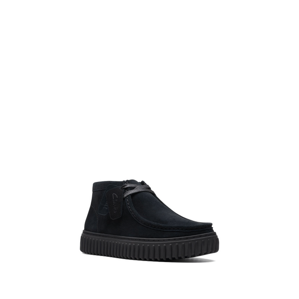 Black suede ankle shoes with a rounded toe, lace-up front, and a textured rubber sole, featuring a subtle logo tag on the side.