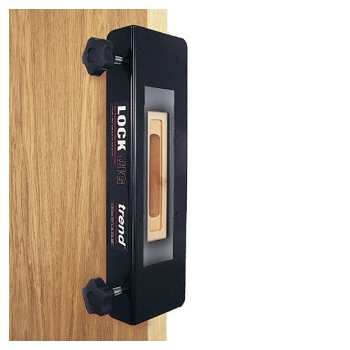 Black LOCK/JIG Lock Jig for routers with a central cut-out, featuring adjustable clamps and a sleek design, mounted on a wooden surface.
