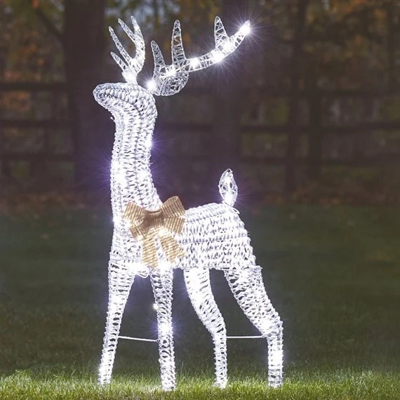 Glittering silver reindeer sculpture adorned with CoolWhite lights, featuring a decorative gold bow, standing 80cm tall in a grassy outdoor setting.