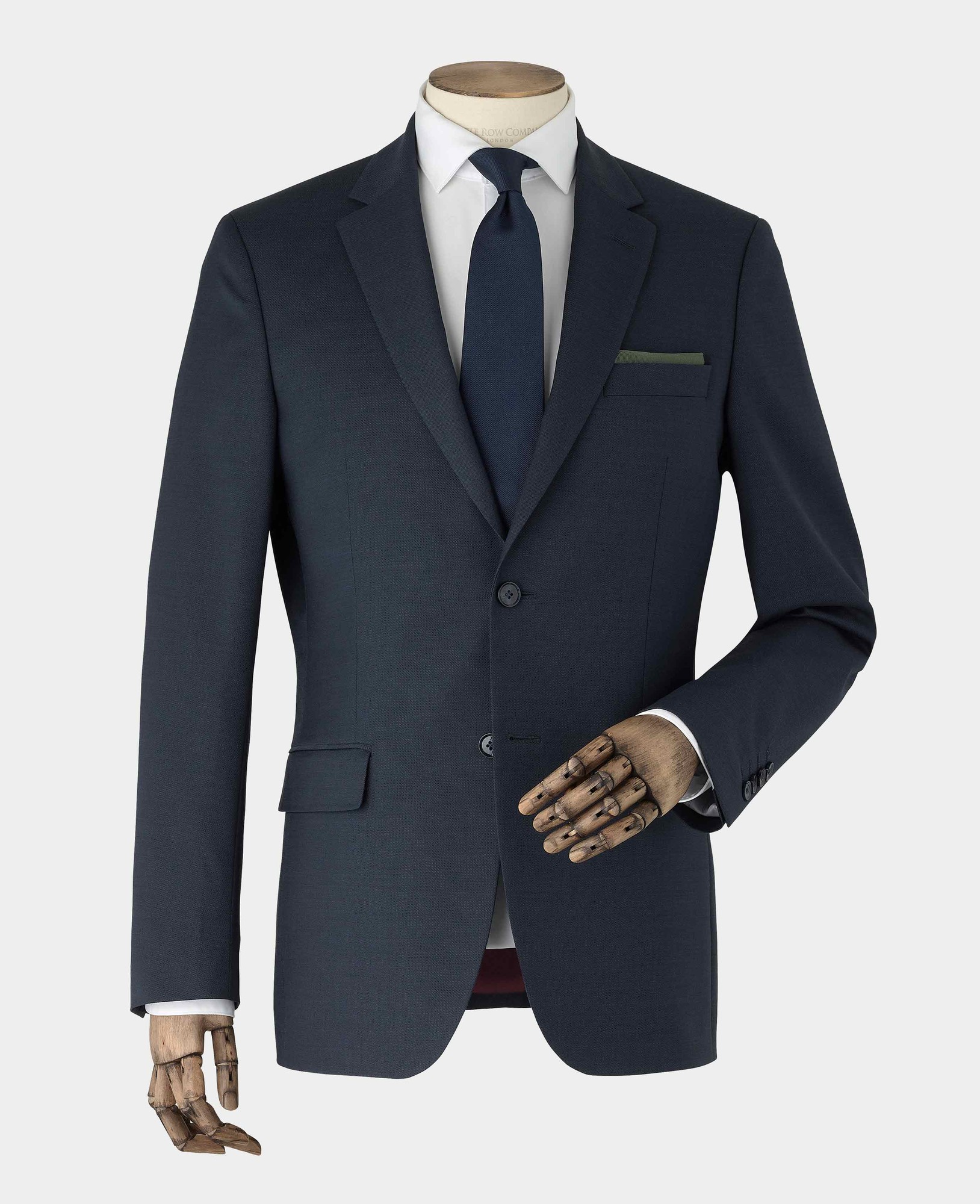 Men's dark navy wool blend suit jacket, size 44 X Long, featuring a single button closure, notch lapels, and a chest pocket, displayed on a mannequin with a wooden hand.